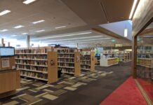 Interior of Lane Cove Library showing book stacks and reading area