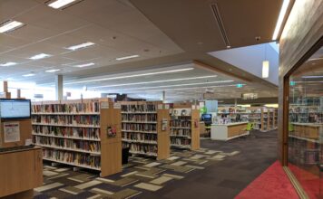 Interior of Lane Cove Library showing book stacks and reading area