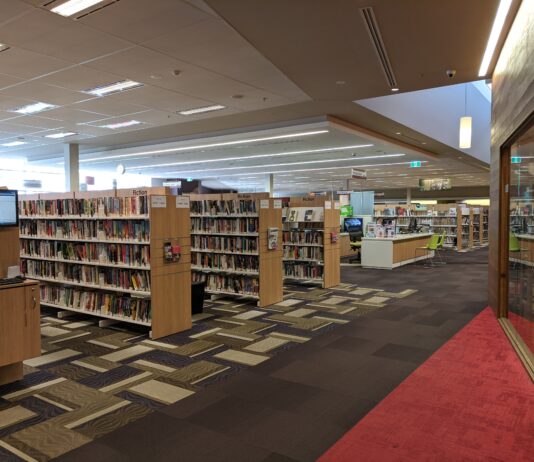 Interior of Lane Cove Library showing book stacks and reading area
