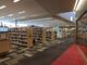 Interior of Lane Cove Library showing book stacks and reading area