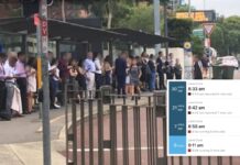 Commuters queuing at the Lane Cove bus stop on the Pacific Highway. An inset shows a real-time departure board with four consecutive route 253 services to Wynyard all running late.