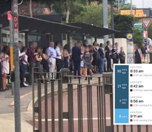 Commuters queuing at the Lane Cove bus stop on the Pacific Highway. An inset shows a real-time departure board with four consecutive route 253 services to Wynyard all running late.
