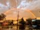 Rainbow over a wet Lane Cove street after Saturday's storm, with a 254 bus at the lights