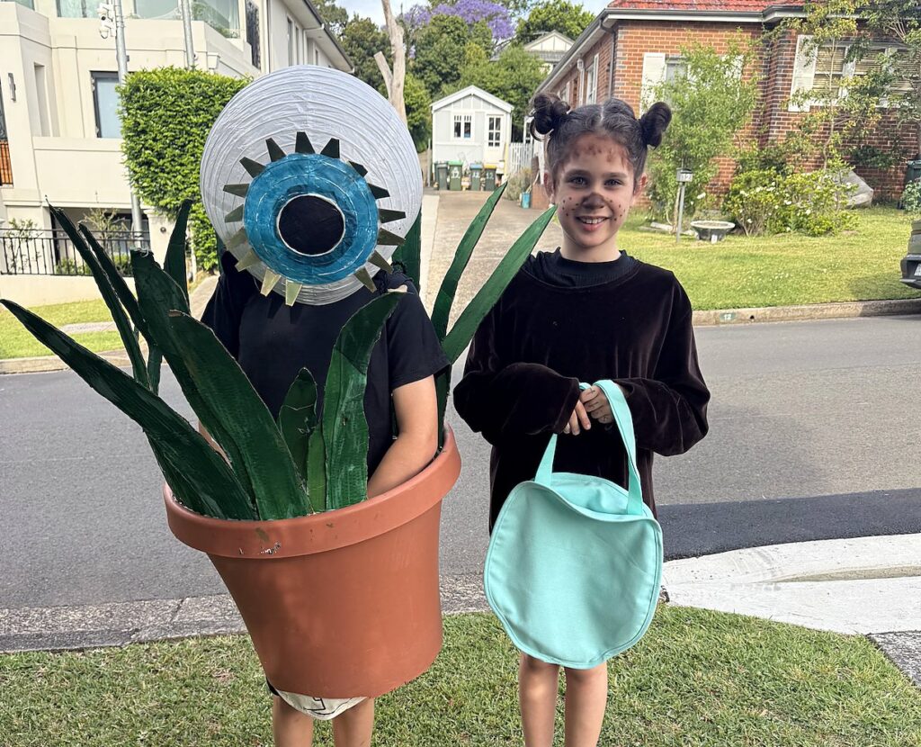 Two children in homemade pot plant and bear Halloween costumes