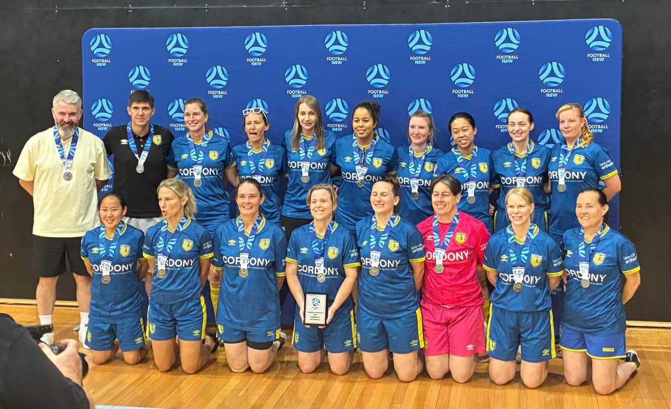 Lane Cove FC Women's O30 Division 1 Yellow team members pose with their medals after a successful season.