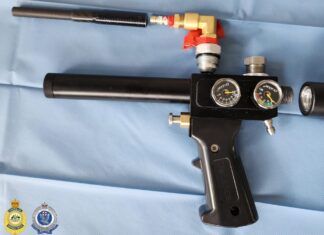 Airgun, drugs and steroids: Lane Cove West home raided in national firearms crackdown Black airgun with a carbon barrel and air cylinder standing upright in a cluttered room next to a printer