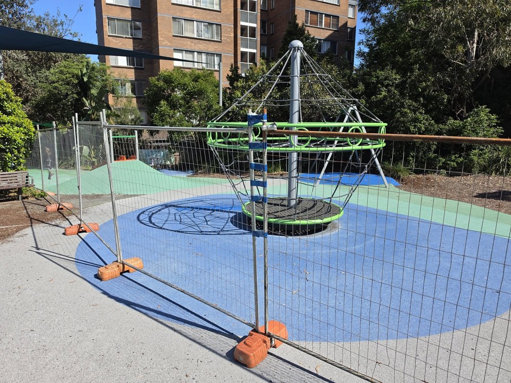Temporary fencing around the Hughes Park playground in Lane Cove during softfall repairs