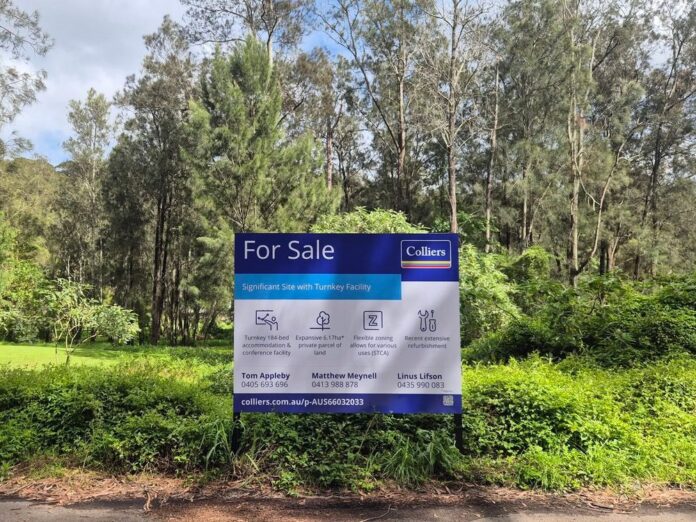 Naamaroo for sale sign Lady Game Drive Colliers For Sale sign in front of bushland and a grassed clearing at Naamaroo, Lady Game Drive, Lindfield